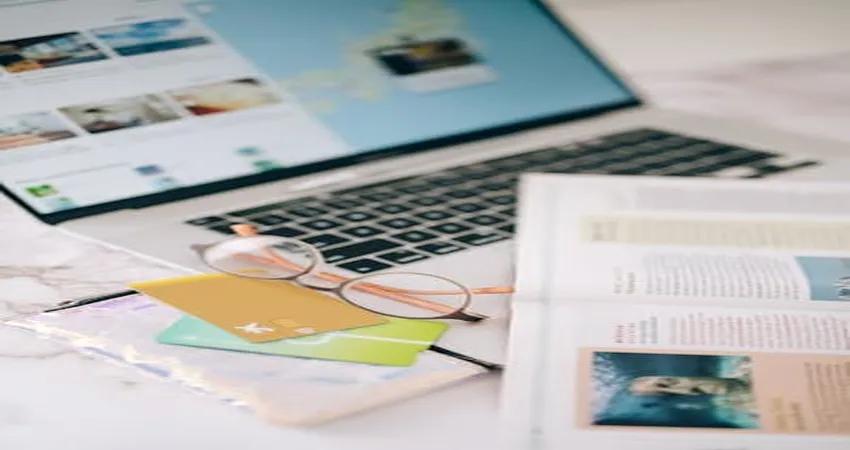 A sleek workstation featuring an open laptop with an AI-powered writing tool (e.g., content generation screen) alongside handwritten notes, creative doodles, and books like "The Adweek Copywriting Handbook." The scene highlights the blend of technology and human creativity in freelance copywriting.